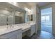 Double vanity bathroom with a large mirror and walk-in shower at 21553 W Papago St, Buckeye, AZ 85326