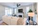 Living room with fireplace, comfortable seating and sliding door access to patio at 15820 S 177Th Dr, Goodyear, AZ 85338