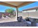 Covered patio with seating area, fire pit, and artificial turf at 15820 S 177Th Dr, Goodyear, AZ 85338
