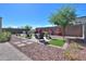 Landscaped backyard featuring a fire pit and seating area at 15820 S 177Th Dr, Goodyear, AZ 85338