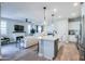 Open floor plan with kitchen island, living area, and fireplace at 15820 S 177Th Dr, Goodyear, AZ 85338