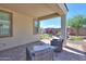 Relaxing covered patio with seating area and view of backyard at 15820 S 177Th Dr, Goodyear, AZ 85338