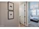 View of hallway with framed art and access to bedroom and bathroom at 15820 S 177Th Dr, Goodyear, AZ 85338
