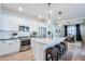 Modern kitchen with white cabinets, quartz countertops, and stainless steel appliances at 15820 S 177Th Dr, Goodyear, AZ 85338