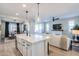 Open kitchen features a large island, white cabinetry, and breakfast bar at 15820 S 177Th Dr, Goodyear, AZ 85338