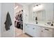 Clean bathroom with white vanity, large mirror, and walk-in closet at 15820 S 177Th Dr, Goodyear, AZ 85338