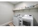 Laundry room with washer, dryer, and shelving for storage at 15820 S 177Th Dr, Goodyear, AZ 85338