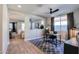 Home office with a desk, chair, and view to living area at 15820 S 177Th Dr, Goodyear, AZ 85338