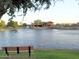 Scenic community lake with clubhouse and walking path at 43298 W Neely Dr, Maricopa, AZ 85138