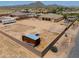 Aerial view of single-story house with large lot and storage container at 7009 W Palomino Way, Coolidge, AZ 85128