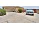 Single story home with attached garage and desert landscaping at 7009 W Palomino Way, Coolidge, AZ 85128