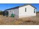 Rear view of manufactured home, showing water tanks and landscaping at 1924 S Smith Rd, Maricopa, AZ 85138