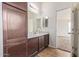 Bright bathroom features a vanity with dark wood cabinets at 1924 S Smith Rd, Maricopa, AZ 85138