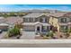 Two-story house with a gray exterior, landscaped yard, and a three-car garage at 10921 W Harrison St, Avondale, AZ 85323