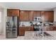 Modern kitchen featuring stainless steel appliances and granite countertops at 10921 W Harrison St, Avondale, AZ 85323