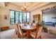 Bright dining room with a large table, chandelier, and window views at 8300 E Dixileta Dr # 253, Scottsdale, AZ 85266
