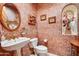 Small bathroom with pedestal sink, toilet, and decorative wall texture at 8300 E Dixileta Dr # 253, Scottsdale, AZ 85266