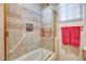 Bathroom with a shower/tub combo, tiled walls, and red towels at 8300 E Dixileta Dr # 253, Scottsdale, AZ 85266