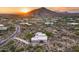 Aerial view of desert house with sunset and mountain views at 8300 E Dixileta Dr # 253, Scottsdale, AZ 85266