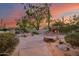 Outdoor patio with fireplace and seating area under an umbrella at 8300 E Dixileta Dr # 253, Scottsdale, AZ 85266