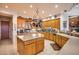 Island kitchen with wood cabinets, granite counters, and a large island at 8300 E Dixileta Dr # 253, Scottsdale, AZ 85266
