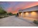 Two-car garage with light-colored doors and desert landscaping at 8300 E Dixileta Dr # 253, Scottsdale, AZ 85266