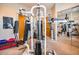 Home gym with weight machine, treadmill, and mirrored wall at 8300 E Dixileta Dr # 253, Scottsdale, AZ 85266