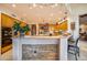 Open kitchen with wood cabinetry, a breakfast bar, and stone backsplash at 8300 E Dixileta Dr # 253, Scottsdale, AZ 85266