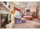 Primary bedroom with fireplace, sitting area, and access to patio at 8300 E Dixileta Dr # 253, Scottsdale, AZ 85266