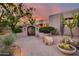 Landscaped entryway with ornate gate and desert plants at 8300 E Dixileta Dr # 253, Scottsdale, AZ 85266