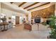 Bright living room showcasing a stone fireplace and wood beams at 8300 E Dixileta Dr # 253, Scottsdale, AZ 85266