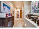Long hallway with tile floors, decorative items, and access to other rooms at 8300 E Dixileta Dr # 253, Scottsdale, AZ 85266