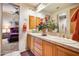 Double vanity bathroom with wood cabinets and a view of a bedroom at 8300 E Dixileta Dr # 253, Scottsdale, AZ 85266