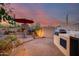 Landscaped backyard with built-in grill and fireplace at 8300 E Dixileta Dr # 253, Scottsdale, AZ 85266