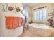 Relaxing bathroom with soaking tub, decorative tile, and large window at 8300 E Dixileta Dr # 253, Scottsdale, AZ 85266
