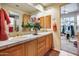 Double sink bathroom with wood cabinets and access to gym at 8300 E Dixileta Dr # 253, Scottsdale, AZ 85266