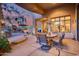 Covered patio features dining area and fireplace at 8300 E Dixileta Dr # 253, Scottsdale, AZ 85266