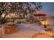 Inviting outdoor space featuring a stone fireplace and water feature at 8300 E Dixileta Dr # 253, Scottsdale, AZ 85266