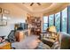 Home office features built-in shelving, comfortable seating, and large windows at 8300 E Dixileta Dr # 253, Scottsdale, AZ 85266