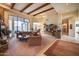 Spacious living room with high ceilings, exposed beams, and fireplace at 8300 E Dixileta Dr # 253, Scottsdale, AZ 85266