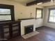 Living room with hardwood floors, built-in shelving, and a fireplace at 1522 W Fillmore St, Phoenix, AZ 85007