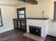 Living room with hardwood floors, built-in shelving, and a fireplace at 1522 W Fillmore St, Phoenix, AZ 85007