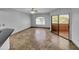 Bright living room featuring tile floors and sliding glass doors leading to a patio at 10030 W Indian School Rd # 257, Phoenix, AZ 85037