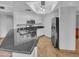 Modern kitchen featuring stainless steel appliances and a large granite island at 10030 W Indian School Rd # 257, Phoenix, AZ 85037