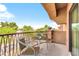 Relaxing balcony with small table and chairs, offering a view of the neighborhood at 21655 N 36Th Ave # 104, Glendale, AZ 85308