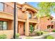 Front view of two-story home with balcony and landscaping at 21655 N 36Th Ave # 104, Glendale, AZ 85308