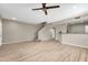Open living room with wood-look floors and kitchen bar at 21655 N 36Th Ave # 104, Glendale, AZ 85308