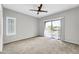 Spacious bedroom with carpet flooring and sliding door to balcony at 21655 N 36Th Ave # 104, Glendale, AZ 85308