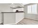 Kitchen with white cabinets, granite counters, and bar seating at 21655 N 36Th Ave # 104, Glendale, AZ 85308