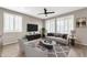 Living room with staged furniture and wood-look floors at 21655 N 36Th Ave # 104, Glendale, AZ 85308